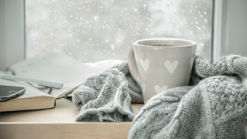 cozy home for winter with warm blankets and candles